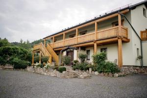 a large house with a balcony and a staircase at Agroturystyka Natura in Pilchowice