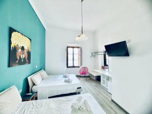 a room with a bed and a couch and a table at La Siesta in La Maddalena +59 photos