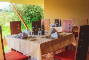 una mesa con un mantel blanco. en Alama Camp Mara en Ololaimutiek