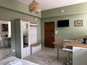 a room with a kitchen with a desk and a tv at Holiday on top City Center in Budapest