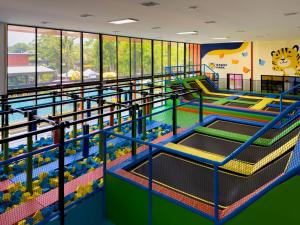 a large indoor play area with slides and water play equipment at Rawayana Central Park Villas in Rawai Beach