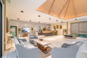 a large living room with couches and a table at Rawayana Central Park Villas in Rawai Beach