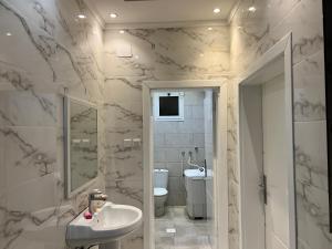 a bathroom with a sink and a toilet at مسكن الفخامة in Taif +60 photos