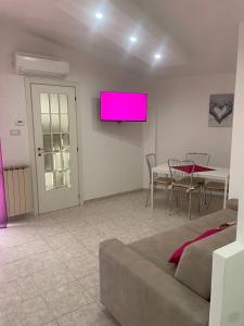 a living room with a couch and a pink screen at Alcione113 Apartment in Francavilla al Mare +11 photos
