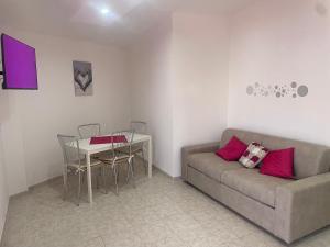 a living room with a couch and a table at Alcione113 Apartment in Francavilla al Mare