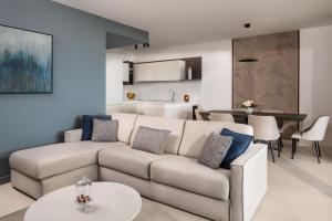 a living room with a couch and a table at Tivoli Portopiccolo Sistiana Apartments in Sistiana