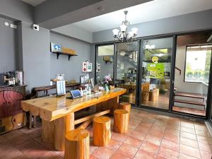a dining room with a wooden table and wooden stools at Chuxu Homestay in Fanlu