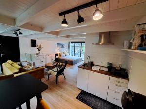 a kitchen and living room with a couch and a table at Stad & Strand Appartement in Middelburg