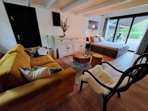 a living room with a couch and a bed at Stad & Strand Appartement in Middelburg