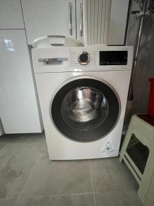 a washer and dryer in a small room at Airport See Viem Apartment in Arnavutköy