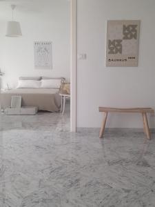 a white room with a bed and a wooden table at Ducale interno 5 in Genova