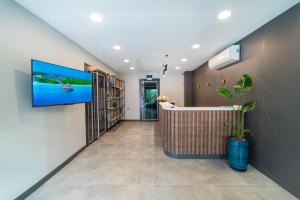 a hallway with a tv hanging on a wall at Deniz Boutique Hotel in Antalya