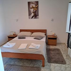 Iva apartman sa bazenom في Donji Zemunik: غرفة نوم عليها سرير وفوط