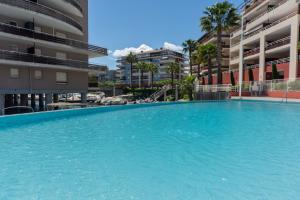 a large swimming pool in the middle of a building at Appartement Marina Privée centre-ville Mandelieu in Mandelieu-la-Napoule