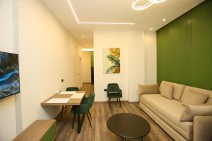 a living room with a couch and a table at Sea La Vie in Vlorë
