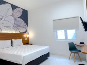 Cordex Hotel Marelan Medan客房内的一张或多张床位