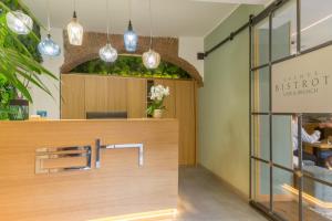 a store front with a wooden counter with pendant lights at Avenue Boutique Hotel in Como