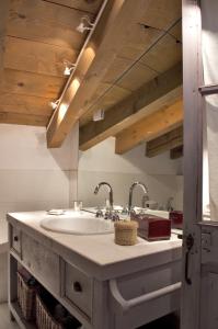 a bathroom with a sink with two faucets at B&B Il Posto delle Rose in Almenno San Salvatore