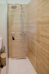 a bathroom with a shower with a toilet at Anasma Boutique Apartments in Kontokali +43 photos