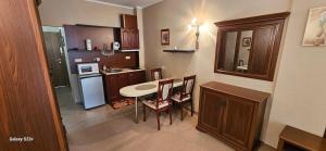 a small kitchen with a table and chairs in it at Частно студио в комплекс Поморие Ризорт in Pomorie