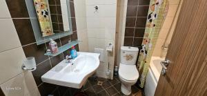 a small bathroom with a sink and a toilet at Частно студио в комплекс Поморие Ризорт in Pomorie +14 photos