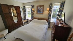 En eller flere senge i et værelse på Farm Cottage