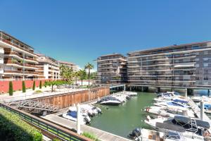 a group of boats in a marina with buildings at Appartement Marina Privée centre-ville Mandelieu in Mandelieu-la-Napoule