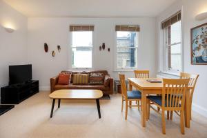 a living room with a couch and a table at Veeve - Charming Hampstead Apartment in London