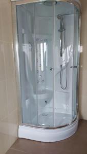 a shower with a glass enclosure in a bathroom at Casa roja in Camariñas