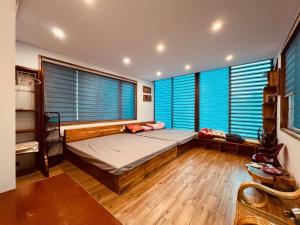 a bedroom with a bed and two large windows at Hòa Hoa Villa in Yên Ha
