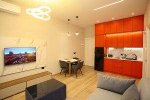 a living room with a couch and a table and a kitchen at Sea La Vie in Vlorë