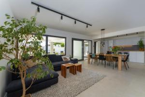 a living room with a couch and a dining room at D Marine villa in Bibinje
