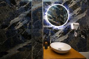 a bathroom with a sink and a mirror on a wall at Sea La Vie in Vlorë +29 photos