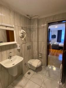 a bathroom with a toilet and a sink at Timex Suites in Istanbul +46 photos