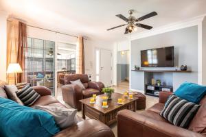 a living room with leather furniture and a flat screen tv at Villa Naranja with private heated pool, sea views, air conditioning, terrace, ITV and BBC channels, Wifi in Callao Salvaje +16 photos