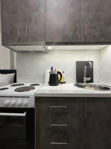 a kitchen with a stove and a sink at Margarita'S GetAway in Patra