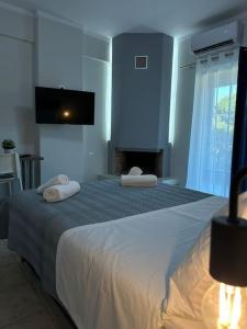 a bedroom with a large bed with two pillows on it at Margarita'S GetAway in Patra