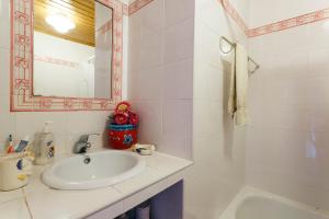 a bathroom with a sink and a mirror and a tub at WHome Ericeira Private Villa in Mafra +8 photos