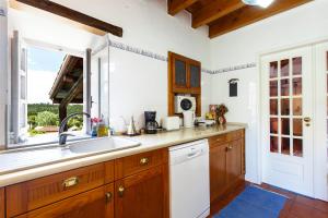 a kitchen with a sink and a window at WHome Ericeira Private Villa in Mafra