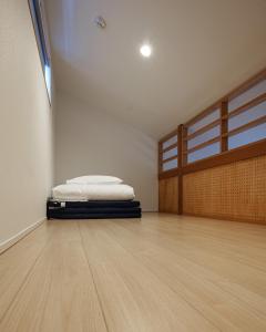a room with a bed in the corner of a room at trive osu east 駅チカ 大須観音通商店街スグ in Nagoya