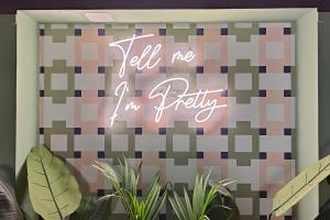 a neon sign that says tell me im pretty at Aparthotel AMMI Nice Lafayette in Nice