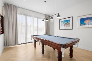 a pool table in a living room with at Casa del Candelabra - Light-Filled Luxury Retreat Minutes from Town in Bellbrae