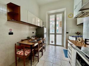 a kitchen with a table and chairs in a room at Casa Tulipani by Holiday World in Savona +23 photos