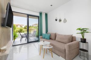 a living room with a couch and a table at Greek Rooms 1 in Kallithea Halkidikis