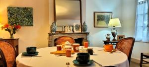 a dining room with a table and a fireplace at Chambre d'hôte AMELIE in Châteauneuf-sur-Charente