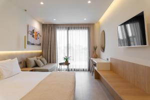 a hotel room with a bed and a desk at Thera luxury living in Nikiti +44 photos