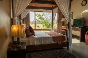 Postel nebo postele na pokoji v ubytování Aahana Resort - Jim Corbett