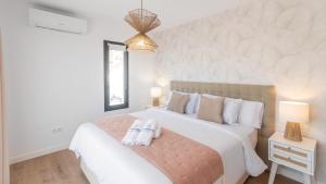 a bedroom with a large bed with towels on it at Villa Turística Palomas Torrox by Ruralidays in Torrox +31 photos