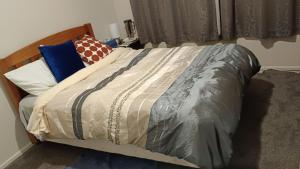 sypialnia z łóżkiem z drewnianym zagłówkiem w obiekcie Bowmont w mieście Invercargill