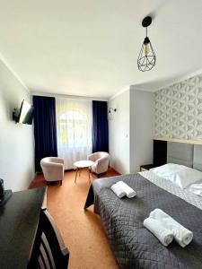 a hotel room with a bed and a desk and chair at Riviera -ADULTS ONLY in Rewal